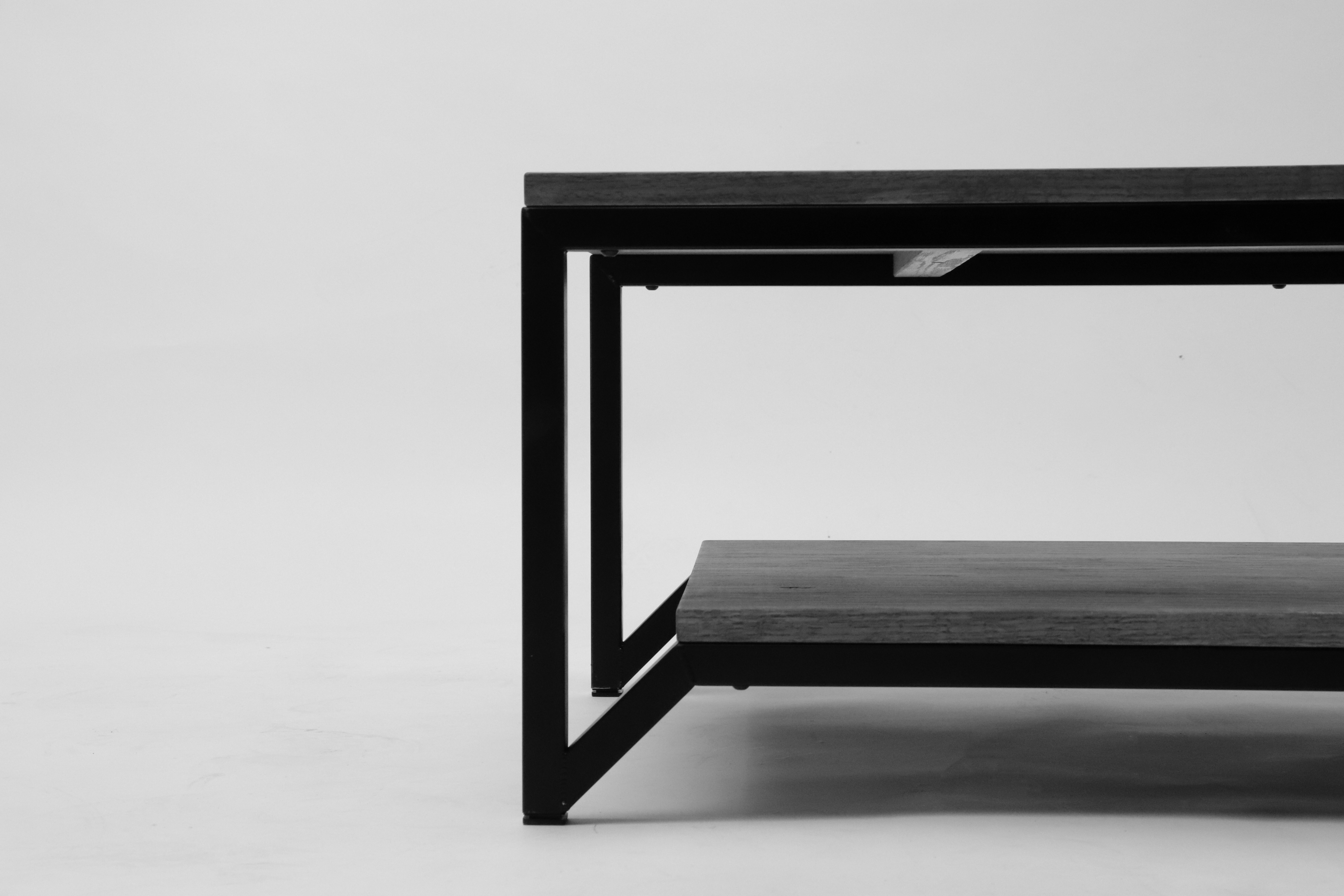 side view of a geometric table made of wood and black metal